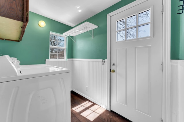 laundry area with wainscoting, dark wood-type flooring, washing machine and dryer, and laundry area