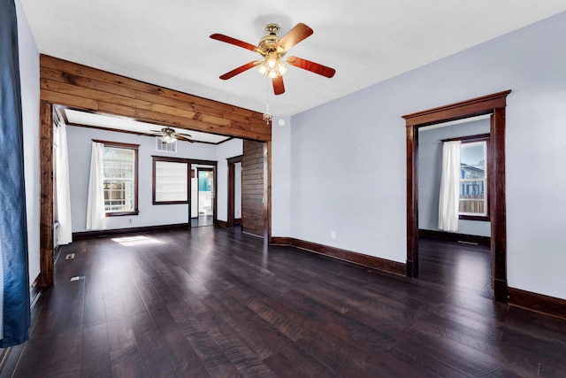 spare room with baseboards, ceiling fan, and hardwood / wood-style flooring