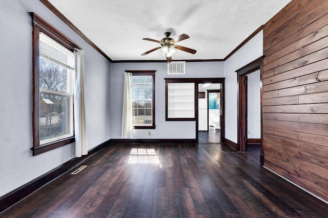 spare room with visible vents, baseboards, ceiling fan, a textured ceiling, and wood-type flooring