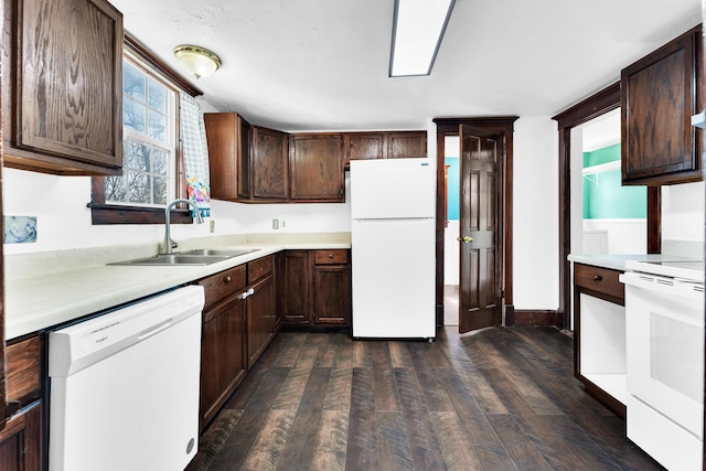 kitchen featuring a sink, dark brown cabinetry, light countertops, white appliances, and dark wood-style flooring