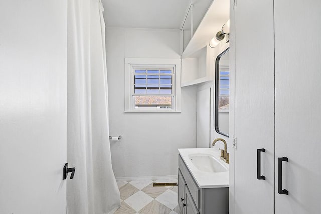 bathroom with baseboards and vanity