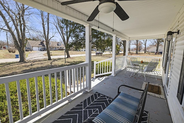 balcony featuring a porch and ceiling fan