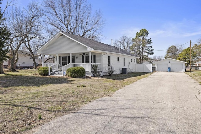 view of front of home with an outbuilding, a ceiling fan, fence, a porch, and a garage