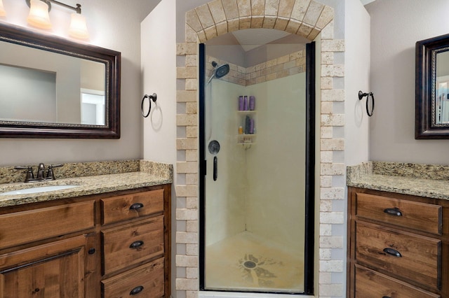 bathroom featuring a shower stall and vanity