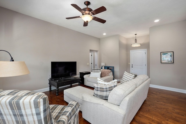 living room featuring baseboards, dark wood-style floors, and a ceiling fan