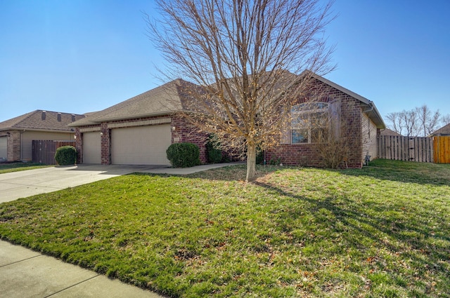 ranch-style house featuring a front lawn, fence, concrete driveway, an attached garage, and brick siding