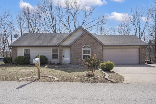 single story home featuring brick siding, an attached garage, and driveway