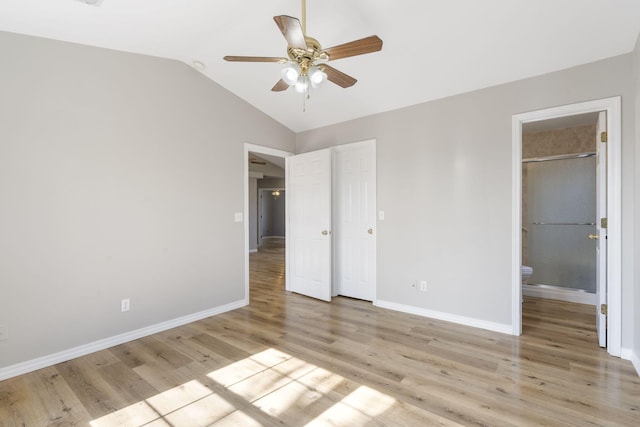 unfurnished bedroom featuring ceiling fan, baseboards, light wood-type flooring, and lofted ceiling