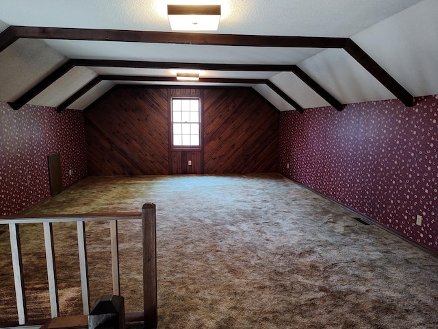 bonus room with wallpapered walls, lofted ceiling with beams, and carpet floors