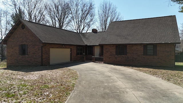 view of front of home featuring an attached garage, a chimney, a shingled roof, concrete driveway, and brick siding