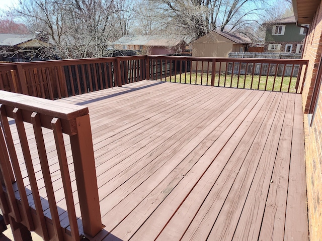 deck featuring a lawn and fence