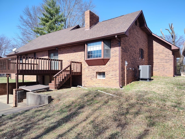 rear view of house featuring brick siding, central air condition unit, stairs, roof with shingles, and a chimney