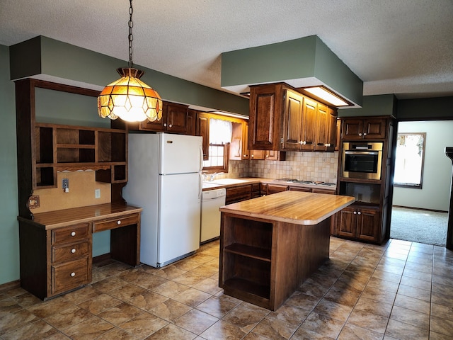 kitchen featuring pendant lighting, open shelves, tasteful backsplash, white appliances, and butcher block counters