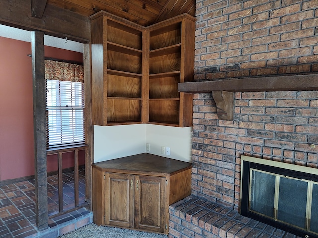 unfurnished office featuring baseboards and brick floor