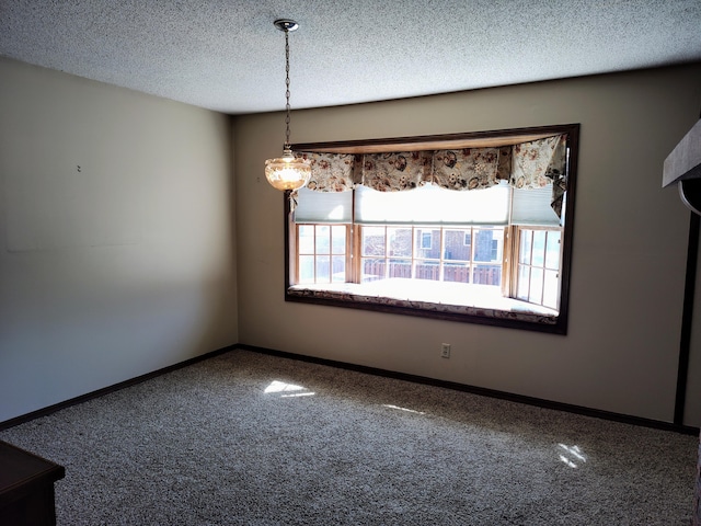 unfurnished room with baseboards and a textured ceiling