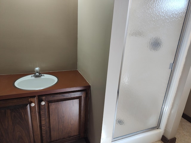 full bathroom featuring a shower stall and a sink