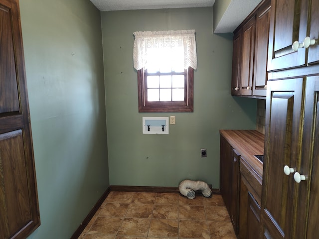 clothes washing area with washer hookup, cabinet space, baseboards, and electric dryer hookup