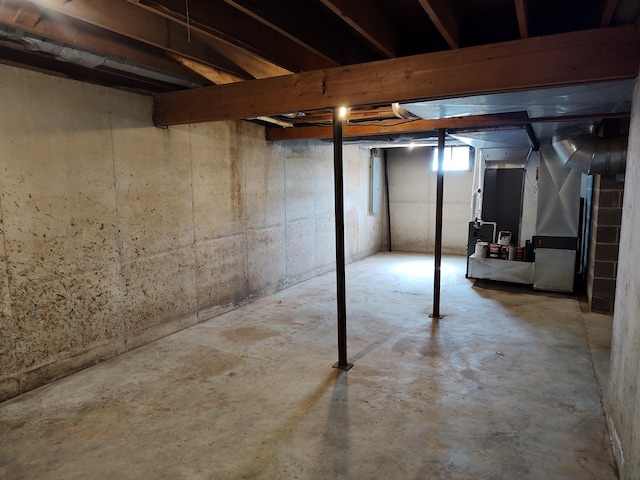 unfinished basement featuring heating unit