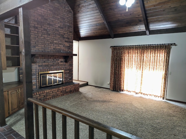 unfurnished living room with a brick fireplace, wood ceiling, vaulted ceiling with beams, and carpet