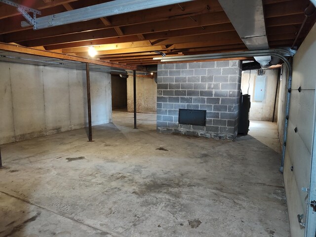 unfinished basement featuring electric panel