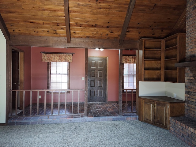 entryway featuring lofted ceiling with beams, carpet, and wooden ceiling