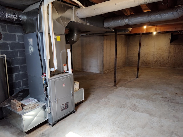 unfinished basement featuring heating unit