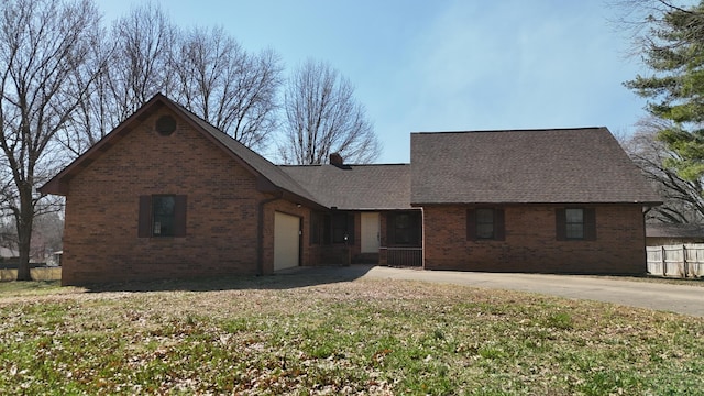 view of front facade featuring brick siding, concrete driveway, an attached garage, and a shingled roof