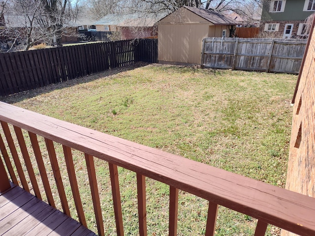 view of yard featuring an outbuilding, a shed, and a fenced backyard