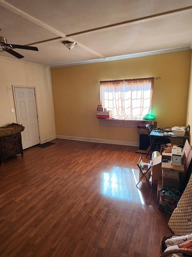 interior space featuring ceiling fan, crown molding, baseboards, and wood finished floors