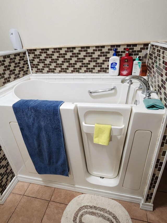 full bathroom featuring tile patterned floors and a garden tub