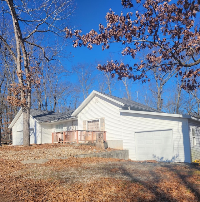 view of home's exterior featuring a deck and a garage