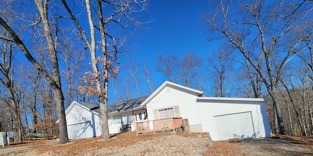 view of home's exterior featuring a garage and driveway