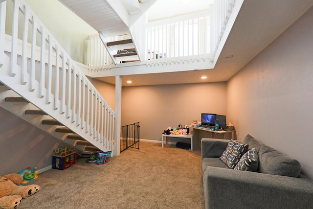 interior space with stairway, a high ceiling, and baseboards