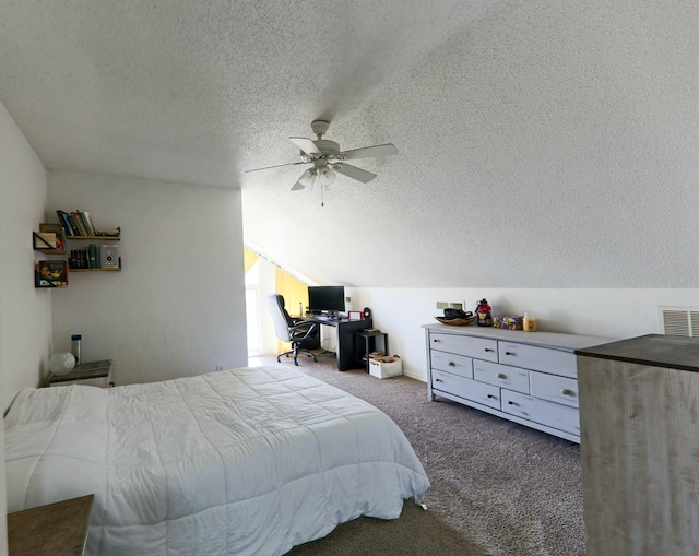 carpeted bedroom with vaulted ceiling, visible vents, and a textured ceiling