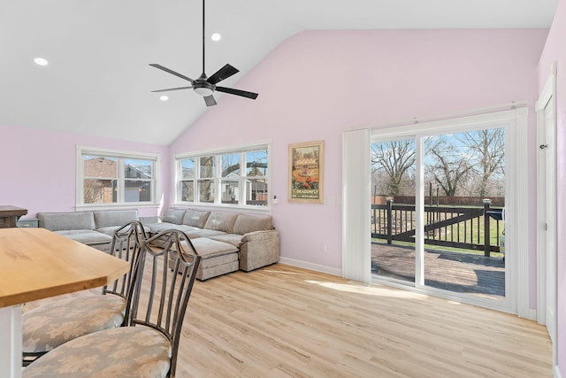 living area with baseboards, recessed lighting, wood finished floors, high vaulted ceiling, and a ceiling fan