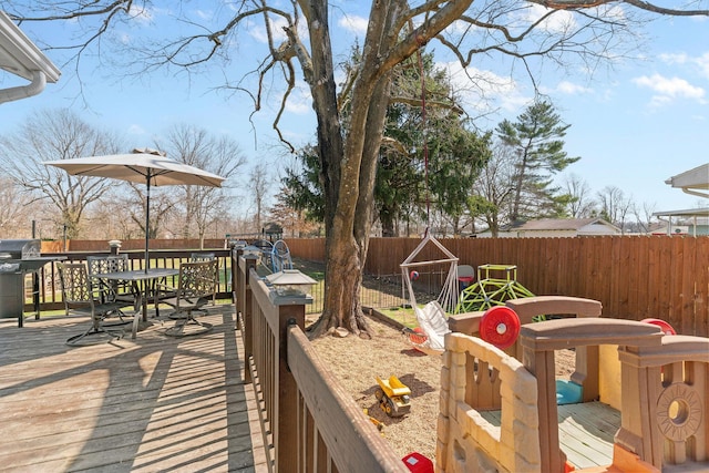 deck featuring a grill and a fenced backyard