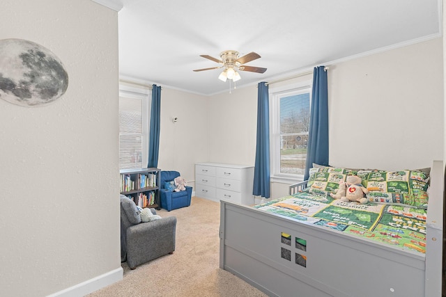 carpeted bedroom featuring ceiling fan, baseboards, and ornamental molding