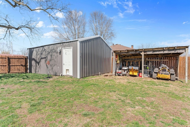 view of pole building featuring fence and a lawn