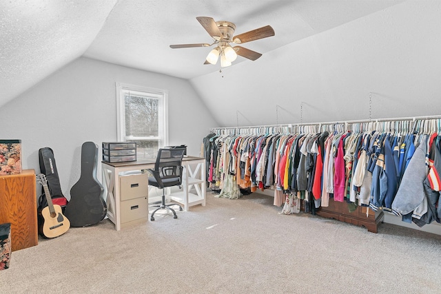 carpeted home office with lofted ceiling, a textured ceiling, and ceiling fan