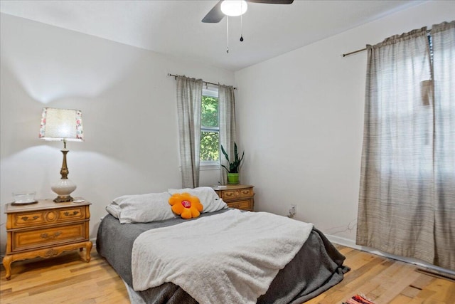 bedroom featuring light wood-style flooring and a ceiling fan