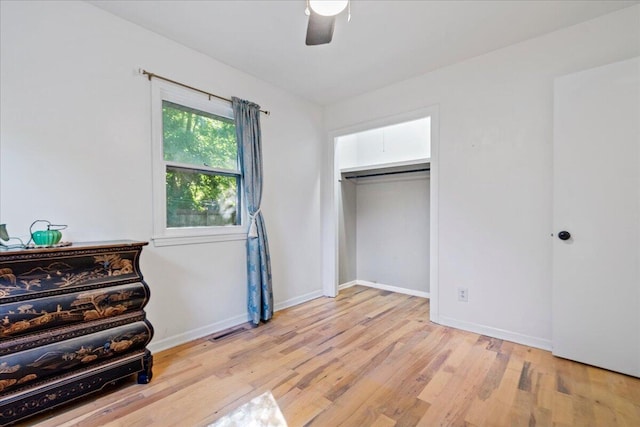 bedroom with visible vents, light wood-style flooring, a ceiling fan, and baseboards