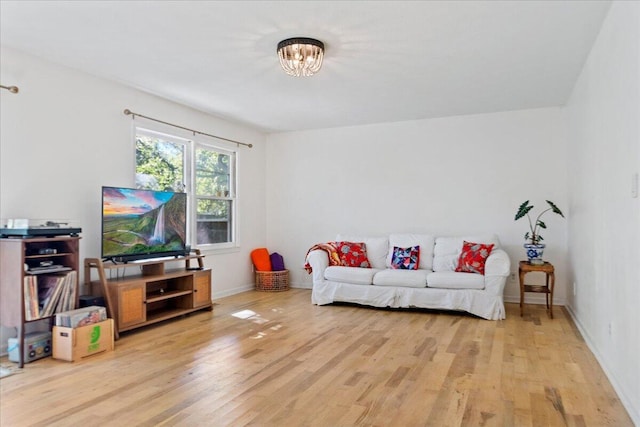 living area featuring an inviting chandelier and light wood-style floors