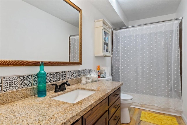 full bath with a shower with shower curtain, toilet, wood finished floors, and vanity