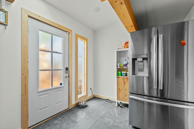 doorway featuring baseboards and a healthy amount of sunlight