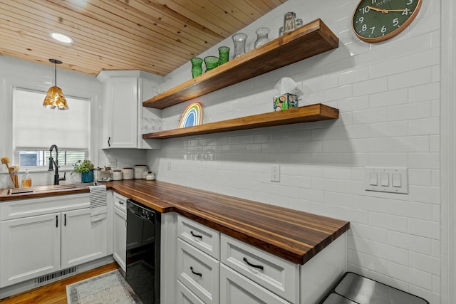 kitchen with visible vents, open shelves, a sink, dishwasher, and butcher block counters