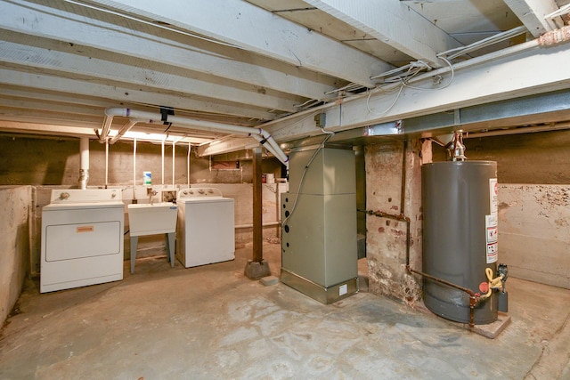 unfinished basement with gas water heater, heating unit, independent washer and dryer, and a sink