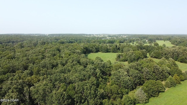 birds eye view of property with a wooded view