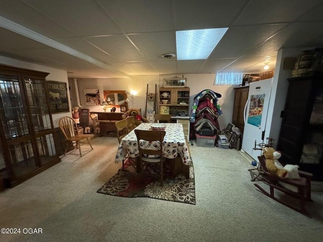 dining room featuring carpet, a paneled ceiling, and visible vents