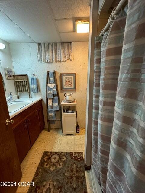 full bath featuring tile patterned floors, vanity, and a shower with curtain