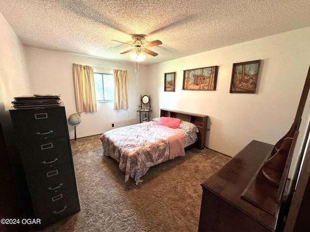 bedroom with a ceiling fan, dark colored carpet, and a textured ceiling